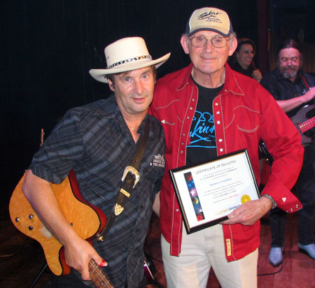DWAYNE presents ALLAN with a certificate commemorating a star named BARBARA TOMKINS