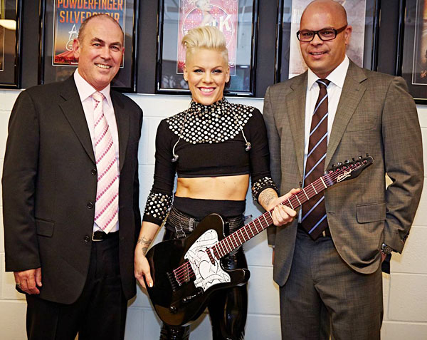 P!NK receiving a custom-made Tomkins Guitar from Tim Worton (Group Director - Arenas, AEG Ogden) and Guy Ngata (General Manager, Allphones Arena) to commemorate her 2013 Sydney concerts at the Allphones Arena.