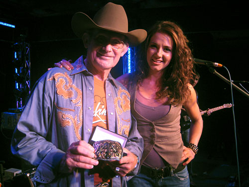 SHEA FISHER surprises guitar-maker Allan Tomkins with a custom made belt buckle