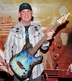 Allan Tomkins with the signed guitar