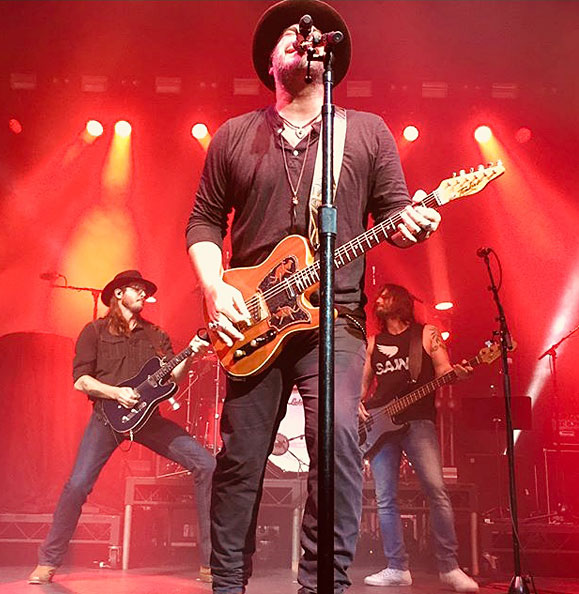 Lee Brice playing a Tomkins Guitar